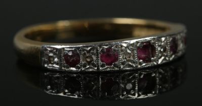 An 18ct gold, diamond and ruby half eternity ring. Size R. 4.36g.