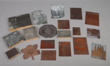 A collection of printing blocks and copper coloured picture plates, including 'Barclays Bank' and