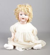 An Armand Marseille bisque headed doll, stamped A.12 to neck.
