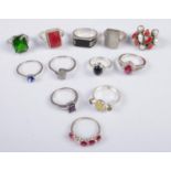 Twelve silver dress rings. Includes colour and clear paste stone examples, etc. 53g