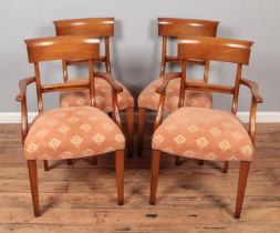 A set of four bar back dining chairs with upholstered seats including two carvers