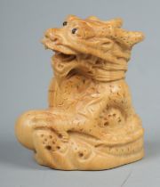 A Japanese carved Netsuke in the form of a dragon
