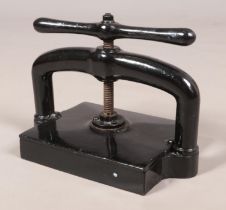 A large Victorian black painted cast iron hand crank book press, marked PBM to base. Base platform