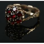 A 9ct gold garnet cluster ring. Size O. 4.53g.