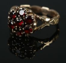 A 9ct gold garnet cluster ring. Size O. 4.53g.