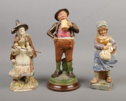 Three 19th century continental figures. Includes Bernard Bloch majolica figure with a stein. Tallest