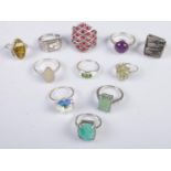 Eleven silver dress rings. Includes large pink stone cluster example, 59g.