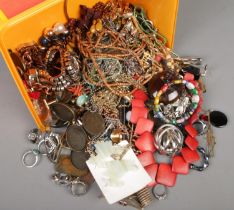 A box of costume jewellery. Includes rings, necklaces, brooches, bracelets, beads, etc.