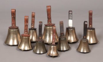 Ten early 20th century campanology hand bells with leather handles.