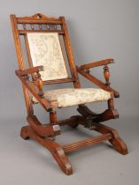 A Victorian mahogany child's rocking chair.