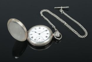 A silver cased full hunter pocket watch with enamel dial, Roman numeral batton markers and