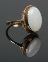 A 9ct gold dress ring set with a large opal stone. Opal stone 1.7cm x 1.2cm. Size Q. 3.32g.