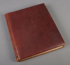 A leather album of scraps with gilding finish to paper and covers fill with mostly Victorian