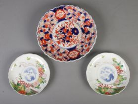 A large early to mid 20th century Japanese imari charger with two smaller examples.
