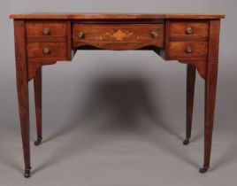 An early 20th century writing desk with leather inset top and tapering supports.