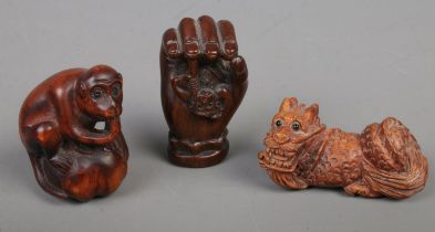 Three Japanese carved Netsuke. Includes monkey, dragon, etc.