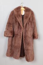 A vintage light brown three quarter length coat