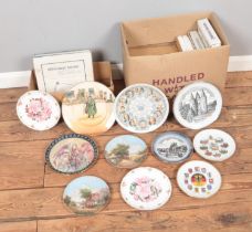 A collection of mostly boxed cabinet plates to include Royal Doulton Dickens Ware, Royal Albert,