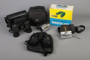 A collection of cameras and binoculars to include Sony Handycam, Tohyoh, Opticron, etc.