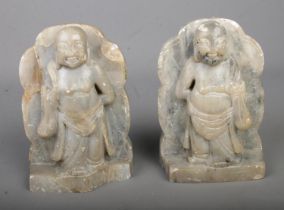 A pair of soapstone bookends formed as mirrored buddhas.