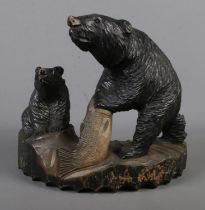 A large hand carved Japanese bear & cub Hx31cm Wx37cm