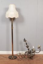 A brass eight branch chandelier together with a brass standard lamp with circular base and lion