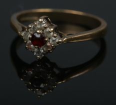 A 9ct Art Deco style garnet and cubic zirconia ring. Size N, 2g.