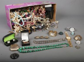 A box of costume jewellery. Includes watches, beads, bangles, earrings, rings, etc.