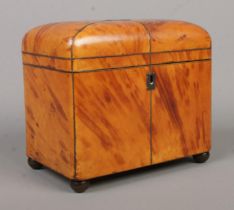 A 19th century tortoiseshell tea caddy. Raised on four metal ball feet and having ivory handles.