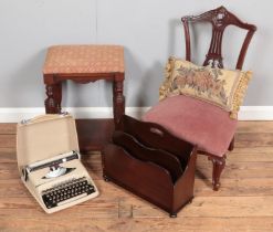 A heavily carved nursing chair together with an upholstered stool, magazine rack and student