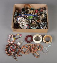 A box of assorted costume jewellery to include bracelets, necklaces, brooches, etc. Also include