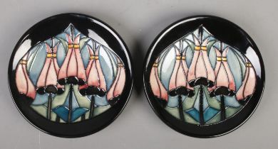 A pair of Moorcroft pottery pin dishes/coasters decorated in a floral design by Kerry Goodwin.