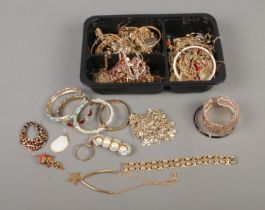 A tray of gold tone costume jewellery and accessories to include necklaces, earrings, bangles,