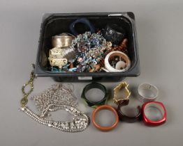 A box of assorted costume jewellery to include bangles, bracelets, necklaces, pendants, etc.