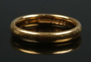 A 22ct gold wedding band. Size N. 5.34g.