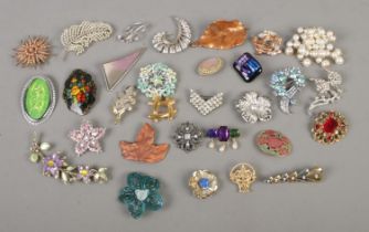 A collection of costume jewellery brooches to include Monet, Movitex, leaf, and floral examples.