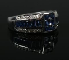 An 18ct White Gold, Diamond and Sapphire ring, with a row of baguette cut sapphires between two rows