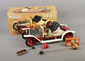 A boxed Mamod Live Steam Roadster featuring black leather seats and red spoked wheels.