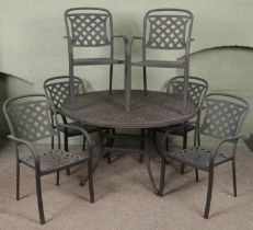 A metal garden table and six chairs.