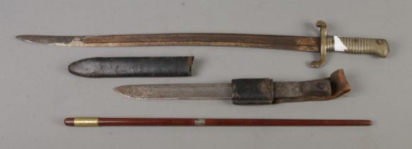 Two unmarked bayonets, one possibly French, along with a gentleman's swagger stick. CANNOT POST