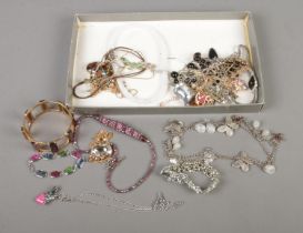 A tray of assorted costume jewellery to include several name brands such as Freedom, Disney, Laura