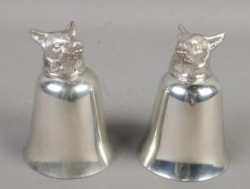 A pair of polished pewter stirrup cups with fox head finials. 10cm.