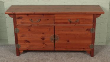 A Chinese style pine side cabinet. Hx72cm Wx140cm Dx40cm