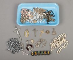 A collection of religious jewellery to include rosaries, crucifixes, pendants, etc.