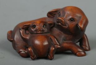 A Japanese carved Netsuke in the form of a pig and piglet