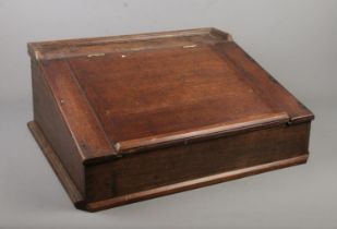 An oak table top writing slope.