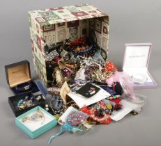 A box of costume jewellery. Includes brooches, beads, earrings, rings, etc.