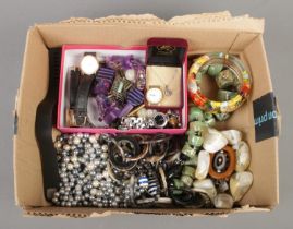 A tray of assorted costume jewellery, to include decorative belt buckle, opal necklace, bangles