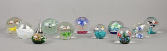 Eleven glass paperweights, to include lizard, birds and butterflies examples.