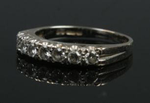 An 18ct white gold seven stone diamond ring. Size P. 3.52g.